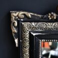 Miroir ancien en bois noir et doré
